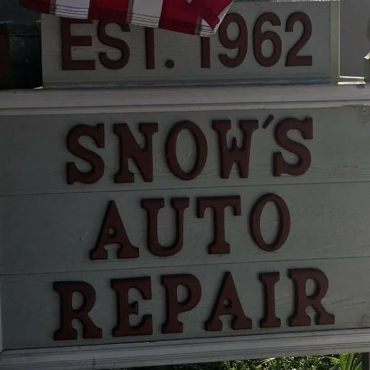 The routed wooden sign at Snow's Auto Repair reading Est. 1962