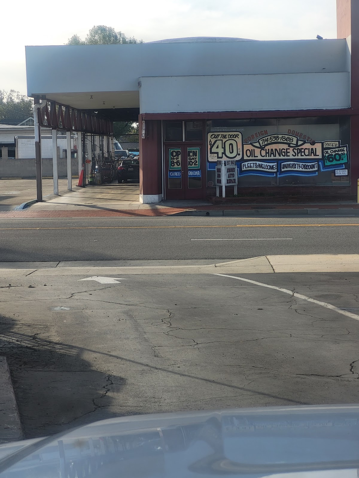 Snow's Auto Repair storefront on Chapman Avenue with hand painted window signs