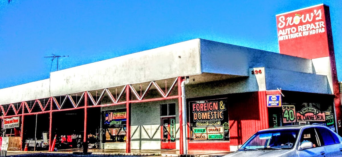 The red Snow's Auto Repair pole sign and open service bays on Chapman Avenue in Orange