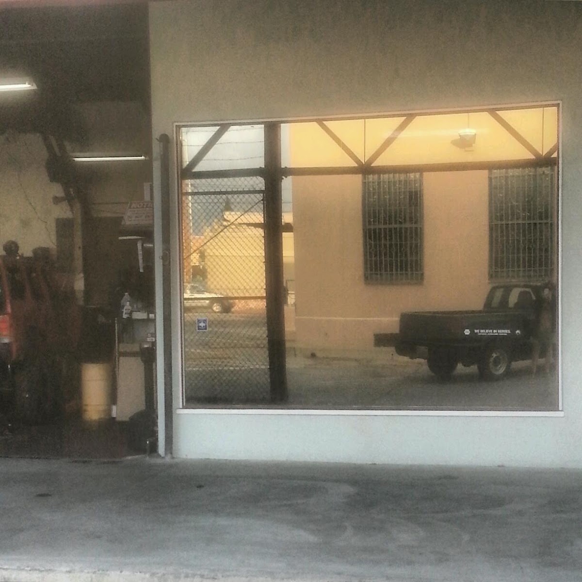 A service bay doorway at Snow's Auto Repair with a truck in the yard beyond